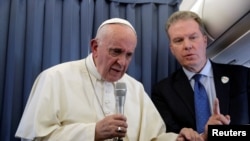 Pope Francis speaks with the media during his flight back to Italy from a trip in Dublin, Ireland, August 26, 2018.