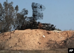 Damaged radars are seen in Tripoli as part of a guided tour for journalists, March 25, 2011