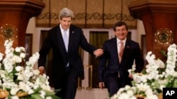 Secretary of State John Kerry, left, enters a news conference with Turkish Foreign Minister Ahmet Davutoglu in Ankara, Turkey. 