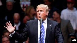 FILE- Republican presidential candidate Donald Trump speaks during a rally at the Times Union Center in Albany, New York, April 11, 2016.