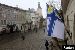 A Ukrainian Naval Forces flag is on display at the city hall building in Lviv, in support of Ukrainian military sailors based in Crimea, March 6, 2014.