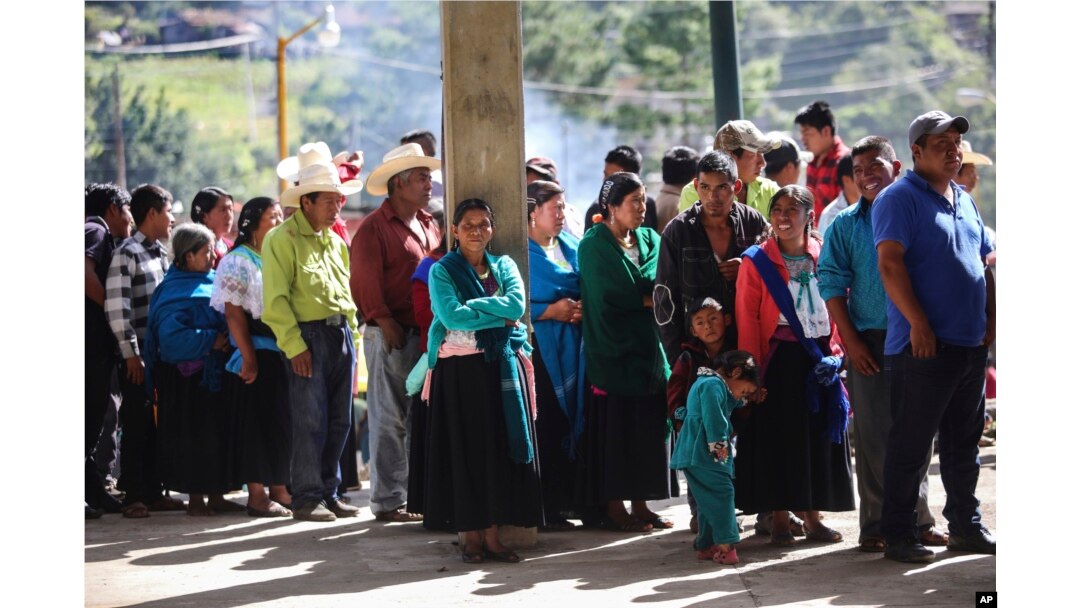 People wait to vote at a polling station during general elections in the indigenous community of Soledad Atzompa, Veracruz state, Mexico, July 1, 2018.