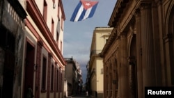 A Cuban flag flies over a street amid concerns about the spread of the coronavirus disease (COVID-19) in downtown Havana, Cuba, July 18, 2021. (REUTERS/Alexandre Meneghini)
