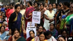 FILE - Women activists participate in a demonstration demanding highest punishment for convicted persons in the Kamduni rape case and the re-arrest of two acquitted persons near the city court in Kolkata, India, Jan. 29, 2016. Police detained three men for the rape and murder of a law student in southern state of Kerala, May 3, 2016.