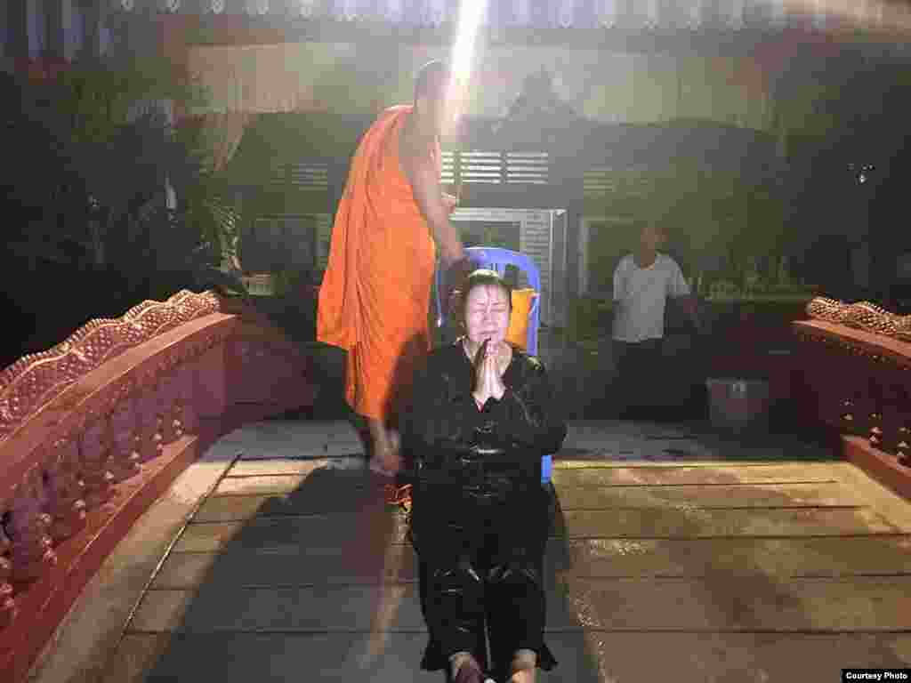 លោកស្រី លឹម មុន្នី ន្ត្រីសិទ្ធិមនុស្សនៃអង្គការអាដហុក ទទួលការប្រោះព្រំពីព្រះសង្ឃ ក្រោយពេលតុលាការរាជធានីភ្នំពេញ សម្រេចដោះលែងលោកស្រី និងសកម្មជនសិទ្ធិមនុស្សបីរូបទៀត និង អគ្គលេខាធិការរងនៃគណៈកម្មាធិការជាតិរៀបចំការបោះឆ្នោត ពីមន្ទីរឃុំឃាំង។ (រូបថតដោយអង្គការលីកាដូ)
