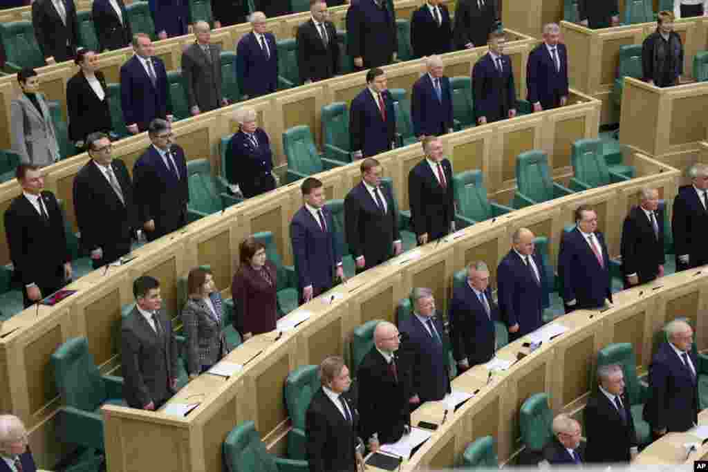 In this photo provided by the Federation Council of the Federal Assembly of the Russian Federation, lawmakers listen to the national song as they attend a session in Moscow.&nbsp;Lawmakers gave President Vladimir Putin permission to use military force outside the country.