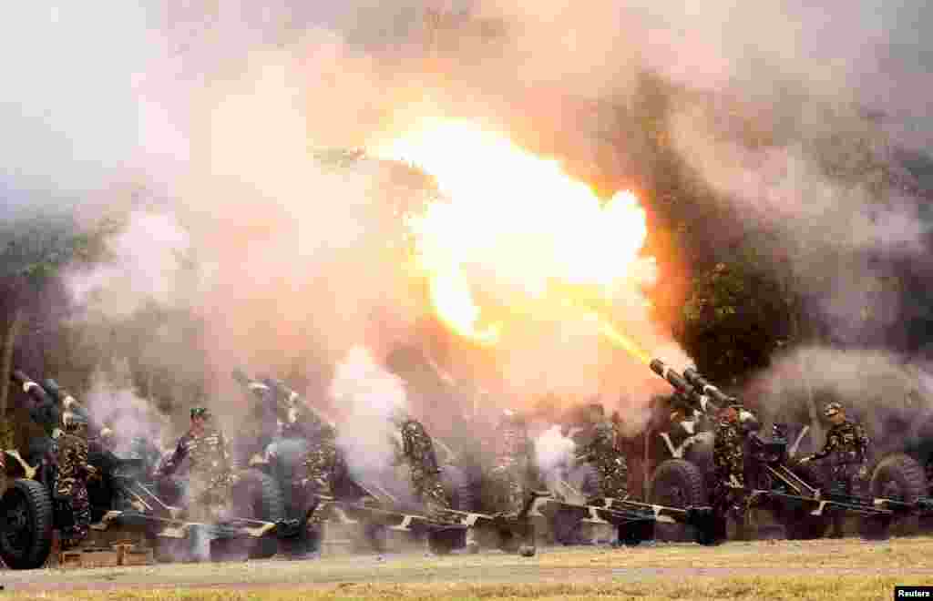 Troops fire 105mm howitzers during the celebration of the 118th Founding Anniversary of the Philippine Army at the military headquarters in Fort Bonifacio, Taguig City, Metro Manila.