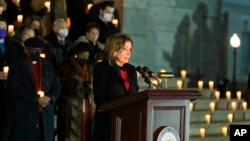 House Speaker Nancy Pelosi leads members of the House and the Senate in observing a moment of silence during a vigil to commemorating the anniversary of the deadly attack on the U.S. Capitol, Jan. 6, 2022, in Washington.