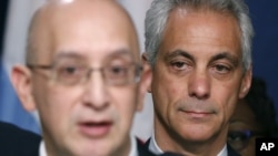 Chicago Mayor Rahm Emanuel, right, listens to Police Superintendent John Escalante during a news conference about new police procedures on Dec. 30, 2015, in Chicago. 