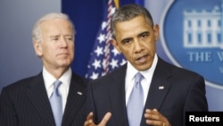 U.S. President Barack Obama delivers remarks next to Vice President Joe Biden (L) after the House of Representatives acted on legislation intended to avoid the "fiscal cliff," at the White House in Washington, Jan. 1, 2013. 