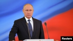 Russian President Vladimir Putin takes the oath during an inauguration ceremony at the Kremlin in Moscow, May 7, 2018. (Sputnik/Aleksey Nikolskyi/Kremlin via Reuters)