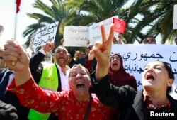 Tunisians shout slogans to demand tighter security within the country during a rally in front of the National Constituents Assembly in Bardo district in Tunis, May 10, 2013.