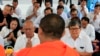 FILE PHOTO- Former Vice President of opposition party Cambodia National Rescue Party Pol Ham, center left, prays together with his former party lawmaker Son Chhay, center right, during a Buddhist ceremony, in Phnom Penh, Cambodia, March 30, 2018. (AP Photo/Heng Sinith)