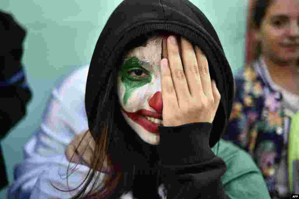 An Algerian demonstrator wearing face paint in the colors of the national flag takes part in an anti-government demonstration in the capital Algiers.