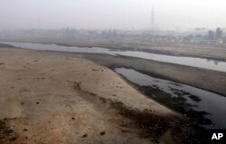 Very little water flows in the Ravi River in Lahore, Pakistan, Dec. 14, 2016. Under the Indus Water Treaty, India has exclusive rights to three Indus basin rivers,