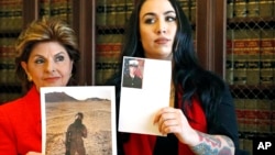 FILE - Former Marine Erika Butner, right, stands with attorney Gloria Allred holding photos of Butner in uniform as she said photographs of her were secretly posted online without her consent.