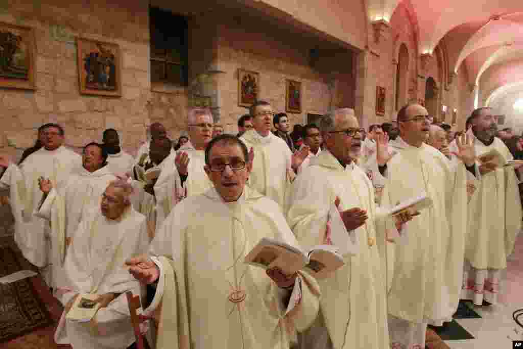 Latin clergies pray as they walk to the Grotto at the end of the Christmas Midnight Mass at Saint Catherine&#39;s Church where Christians believe the Virgin Mary gave birth to Jesus Christ, in the adjacent Church of the Nativity in Bethlehem, West Bank, Dec. 25, 2016.