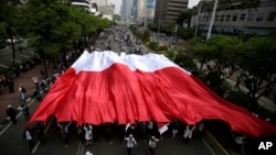 Para pendukung Capres 02 Prabowo Subianto membawa bendera Merah Putih raksasa pada aksi demo di Jakarta, Rabu (22/5). 