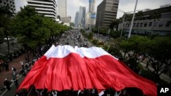 Pendukung Capres 02 Prabowo Subianto menggelar bendera Merah Putih dalam aksi protes di Jakarta, 22 Mei 2019..