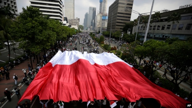 Pendukung Capres 02 Prabowo Subianto menggelar bendera Merah Putih dalam aksi protes di Jakarta, 22 Mei 2019..