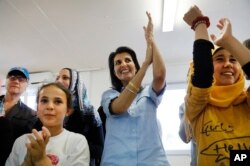 U.S. Ambassador to the U.N. Nikki Haley, center, sings and dances with Syrian refugee children during a visit at the Boynuyogun refugee camp near Hatay, southern Turkey, May 24, 2017.