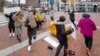 Pro-Thai democracy protesters dance around the monument during the demonstration at King Bhumibol Adulyadej Square in Cambridge, MA Nov 22, 2020.