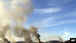 Smoke billows from South Korea's Yeonpyeong island near the border with North Korea, 23 Nov 2010