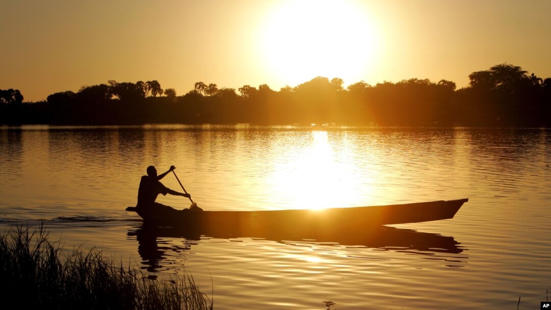 FILE - A fisherman rows a canoe on Lake Chad, in Koudouboul, Chad, Nov. 25, 2006.