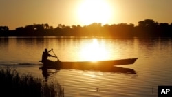 A fisherman rows a canoe on Lake Chad, in Koudouboul, Chad, Nov. 25, 2006. 
