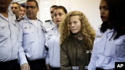 Ahed Tamimi, a blonde 17-year-old from the West Bank village of Nebi Saleh, is brought to a courtroom inside Ofer military prison near Jerusalem, Dec. 28, 2017. 
