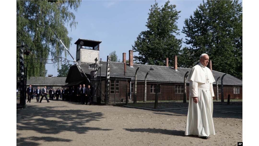 FILE - Pope Francis walks through the gate of the former Nazi German death camp of Auschwitz in Oswiecim, Poland, Friday, July 29, 2016.