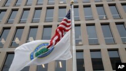 FILE - The flag of the Department of Education flies beneath the U.S. flag, at the Education Department building in Washington, April 3, 2018.