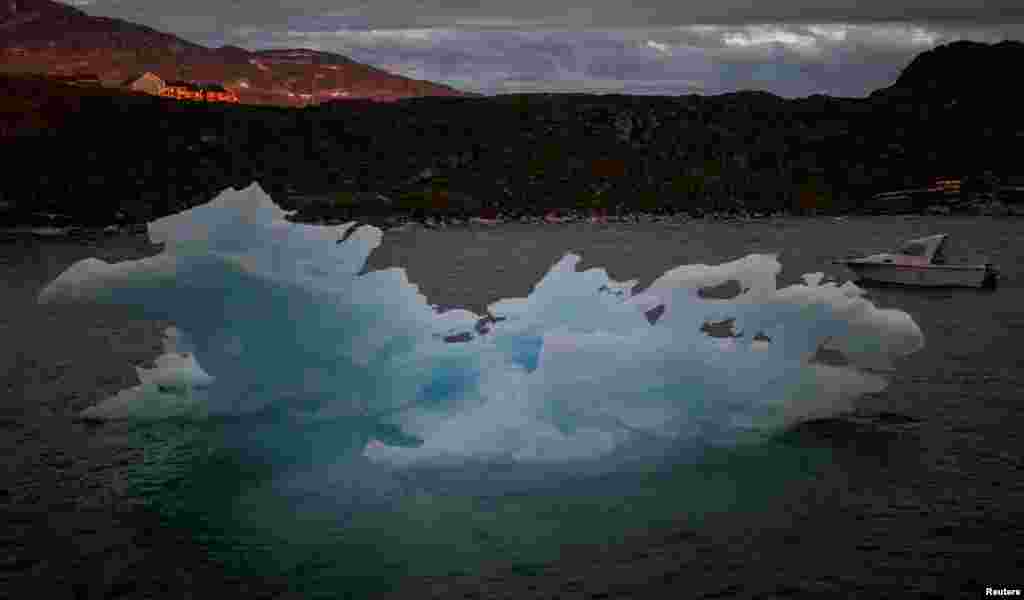 An iceberg passes by during sunset in Nuuk, Greenland, Sept. 7, 2021.