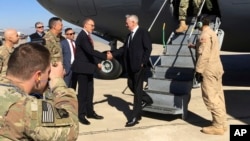 U.S. Secretary of Defense Jim Mattis, center, is greeted by U.S. Ambassador Douglas Silliman as he arrives at Baghdad International Airport on an unannounced trip Monday, Feb. 20, 2017. Mattis said Monday the United States does not intend to seize Iraqi oil, shifting away from an idea proposed by President Donald Trump that has rattled Iraq's leaders. (AP Photo/Lolita Baldor)