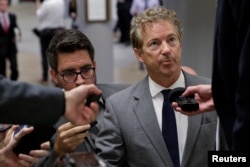 FILE - Senator Rand Paul, R-Kent., speaks to reporters as he arrives for a vote on Capitol Hill in Washington, Oct. 18, 2017.