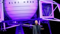 Jeff Bezos speaks in front of a model of Blue Origin's Blue Moon lunar lander, Thursday, May 9, 2019, in Washington. (AP Photo/Patrick Semansky)