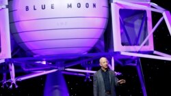 Jeff Bezos speaks in front of a model of Blue Origin's Blue Moon lunar lander, Thursday, May 9, 2019, in Washington. (AP Photo/Patrick Semansky)