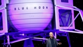 Jeff Bezos speaks in front of a model of Blue Origin's Blue Moon lunar lander, Thursday, May 9, 2019, in Washington. (AP Photo/Patrick Semansky)