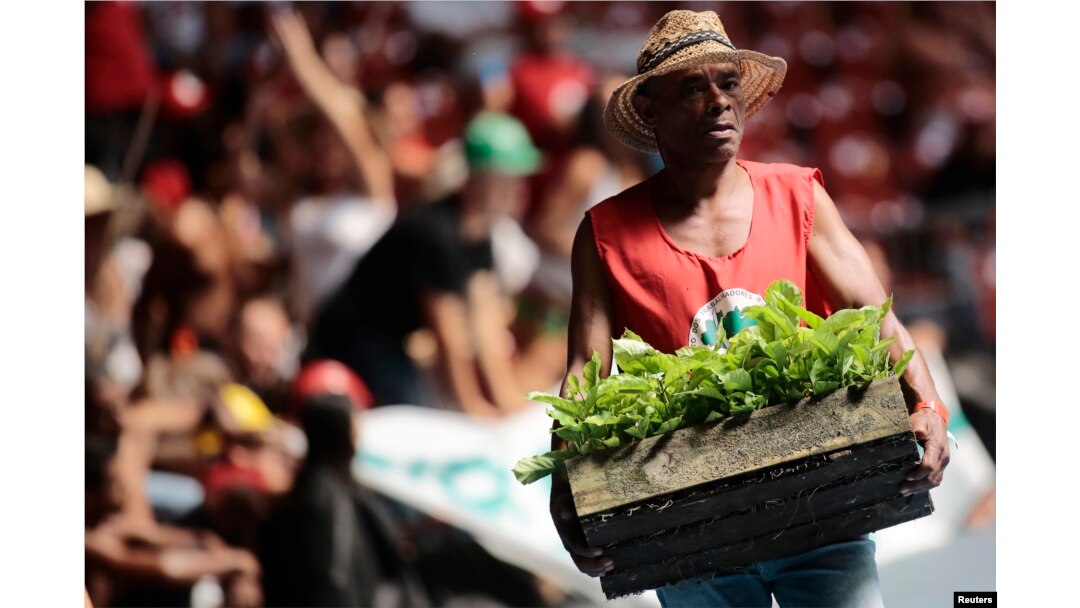 FILE - A member of the Landless Workers Movement attends the opening ceremony of its 6th National Congress in Brasilia, Brazil, Feb. 10, 2014.