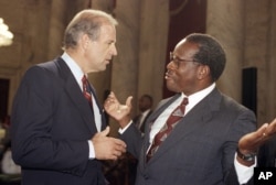 Supreme Court Justice Clarence Thomas gestures while talking with Sen. Joseph Biden, D-Del., chairman of the Senate Judiciary Committee, during a break in the committee's nomination hearing for Thomas on Capitol Hill in Washington, Sept. 13, 1991.