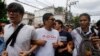 FILE - Student activists gather outside Pathumwan Police Station in Bangkok, Thailand.