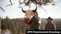Mo (actor Mo Brings Plenty) raises a bison skull in a vision quest ceremony for Kayce Dutton (Luke Grimes) in Season 4, Episode 9 of Paramount+ "Yellowstone."