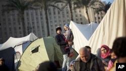 Anti-Mubarak protesters are seen next to their tents at Tahrir Square in Cairo, Egypt, Wednesday, February 9, 2011