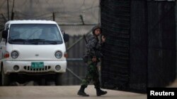 South Korean soldier opens gate of an observation post near the demilitarized zone which separates the two Koreas, Paju, north of Seoul, April 5, 2013.