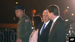 U.S. Vice President Mike Pence, second right, and his wife Karen are escorted to a waiting helicopter by the U.S. Ambassador to Japan William Hagerty, right in Fussa, Japan, Nov. 12, 2018.