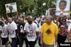 Michael Brown Sr., center, leads a memorial march for his son, Michael Brown, in Ferguson, Missouri, Aug. 8, 2015.