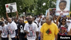 Michael Brown Sr., center, leads a memorial march for his son, Michael Brown, in Ferguson, Missouri, Aug. 8, 2015. 