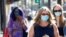 People wearing face protective masks walk on Hollywood Blvd during the outbreak of the coronavirus disease (COVID-19), in Los Angeles, California, U.S., March 29, 2021. 