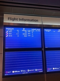 Flight information at an airport shows that airlines cut flights during the coronavirus pandemic.