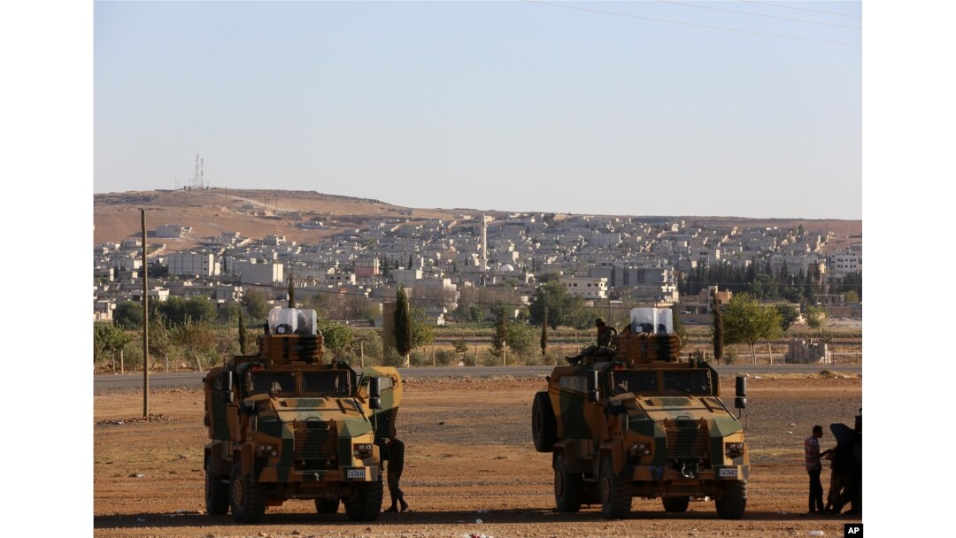 FILE - Turkish soldiers take up position a few hundreds meters from the border with Syria as fighting intensified with Islamic State militants.